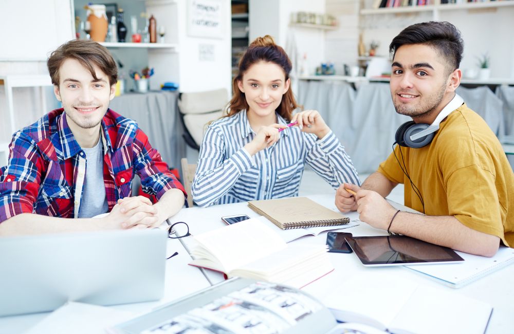 3 students on a office table